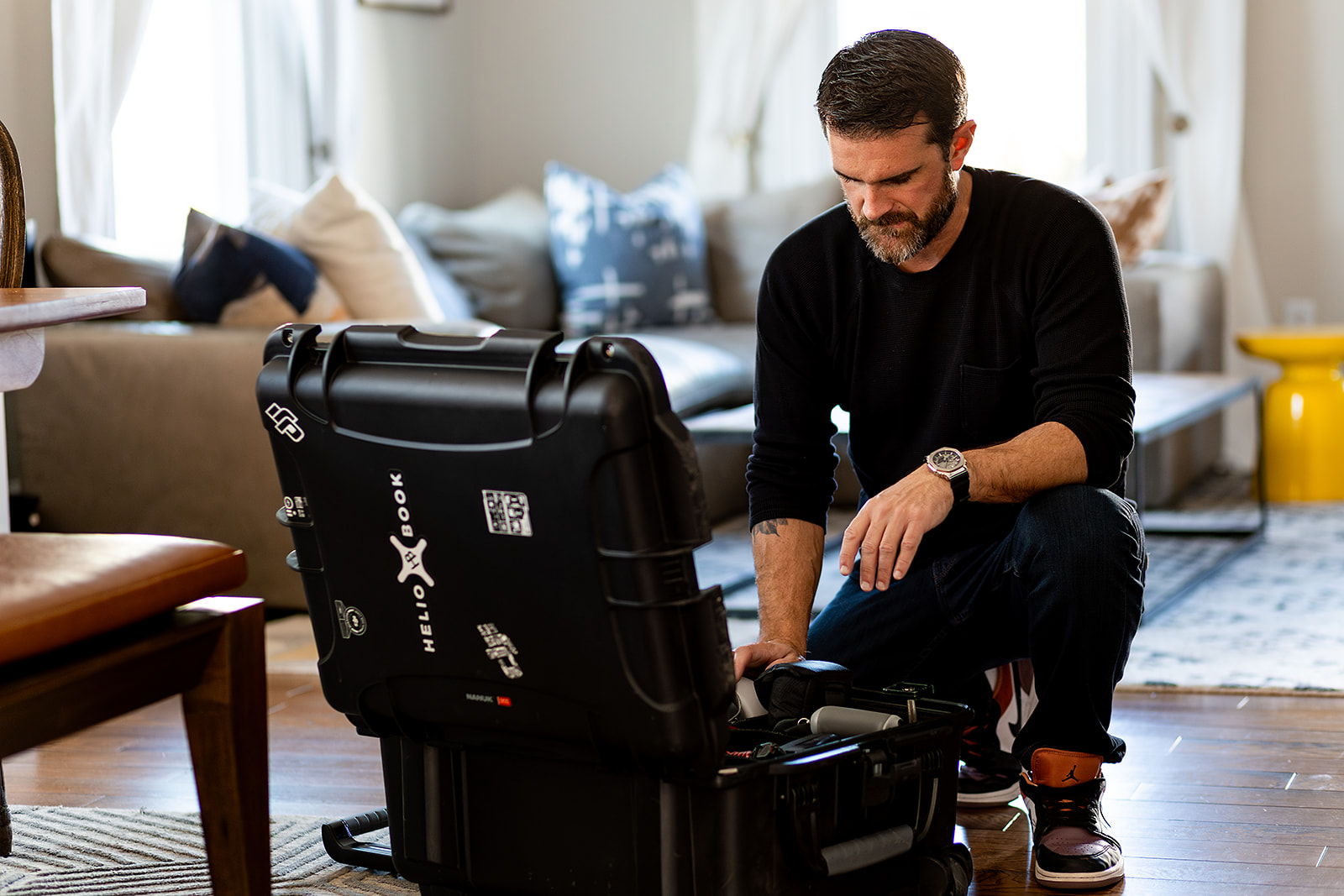 photo of Photographer looking in his bag of equipment.