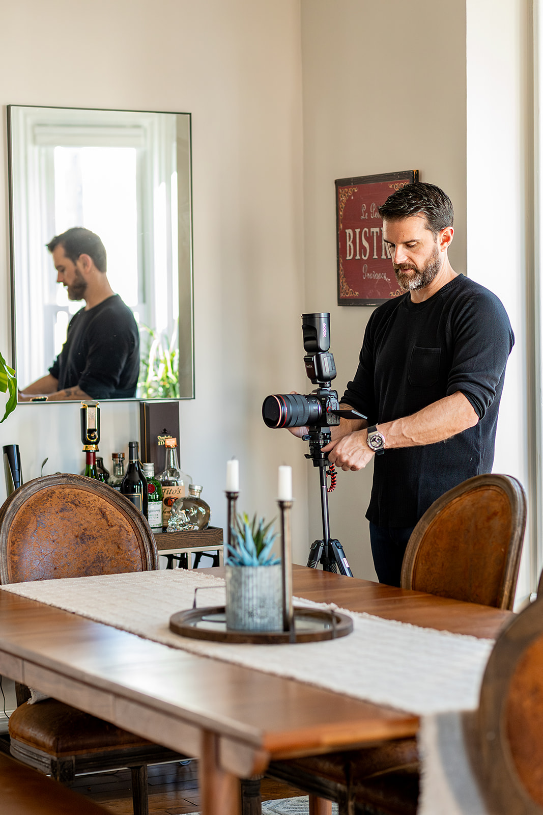 Real Estate photographer setting up camera in dining room to capture the space. 