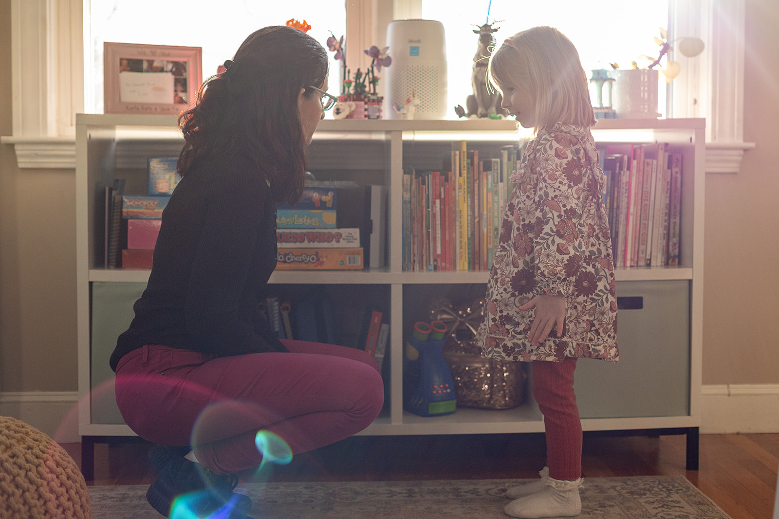 Photo of professional organizer, 
Shira, interacting with a child about clean up!